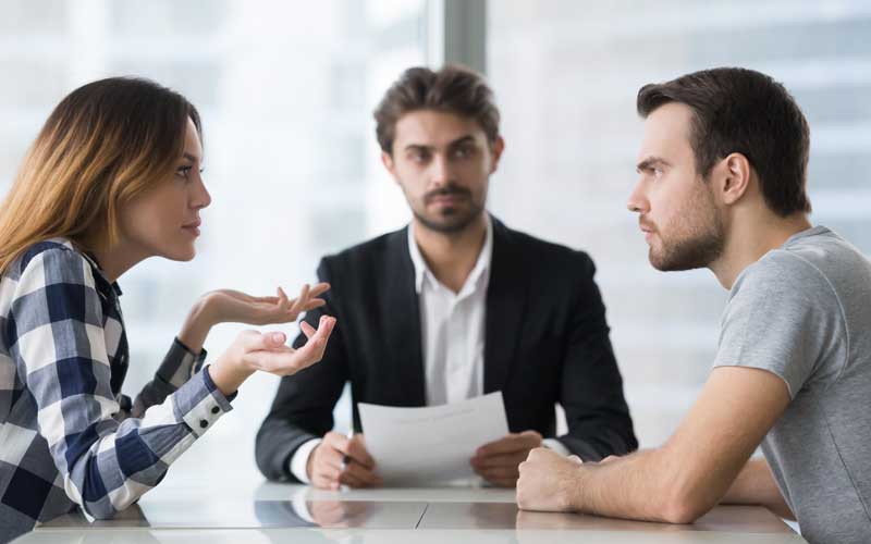 Divorce mediation session with a mediator helping a couple discuss and resolve divorce-related issues